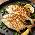 Whole golden pomfret with bright yellow fins and silver-gold skin